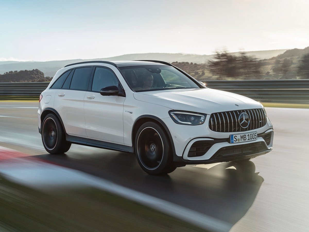 2022 BMW X3 vs. 2022 Mercedes-Benz GLC Comparison 1 2022 Mercedes-AMG GLC 63 S SUV White Front Quarter View in Motion