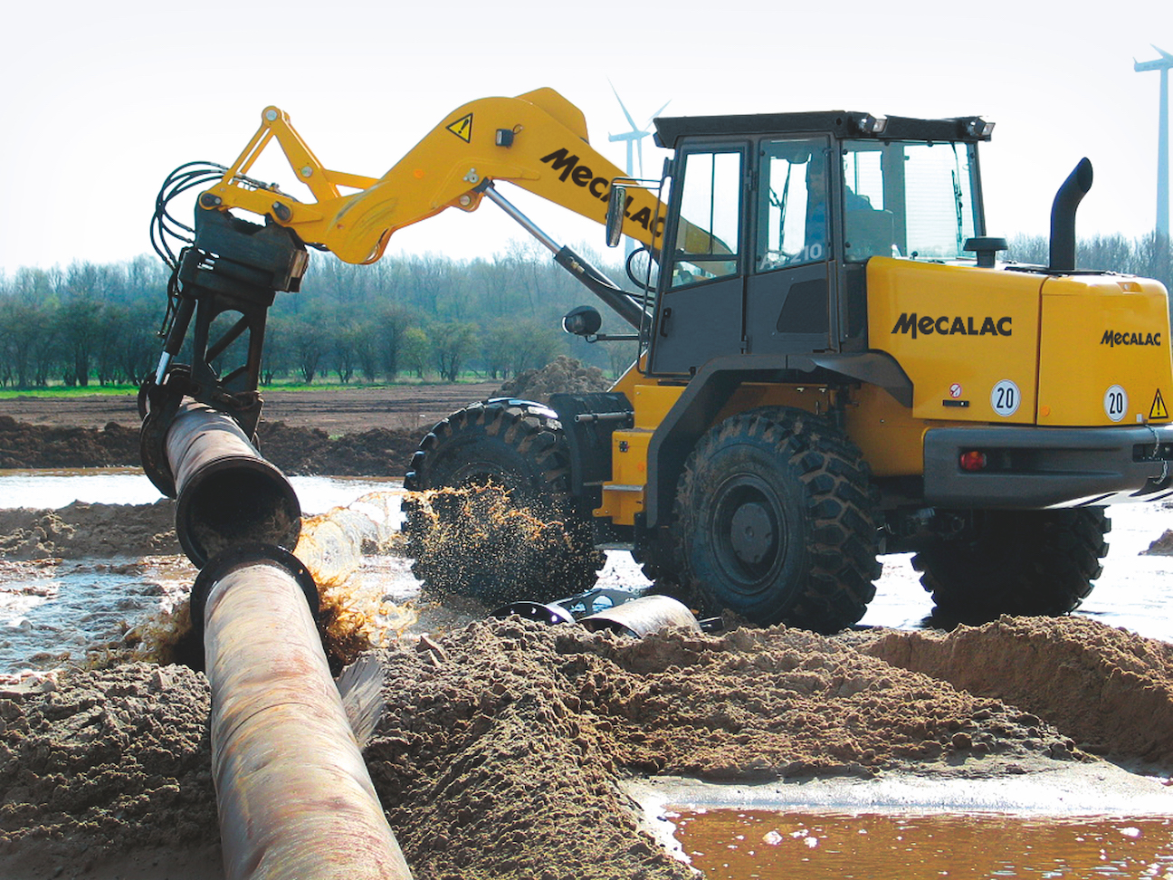 Wheel loaders up the ante on versatility, technology 3 Mecalac AS210e wheel loader laying pipe